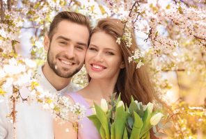 Young lovely couple walking in spring park